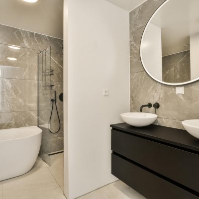 a-bathroom-with-two-sinks-and-a-shower-and-mirror-2023-11-27-05-17-44-utc.2